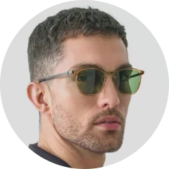 A man wearing sunglasses looking at the camera.